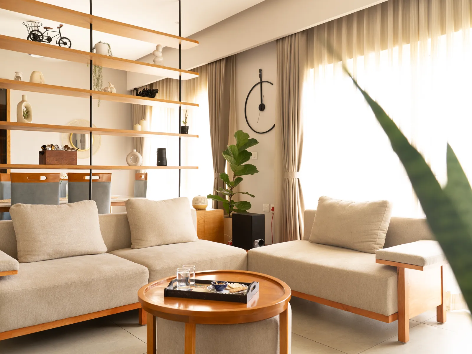 Beige sofas and round oak coffee table — Amlan's Residence